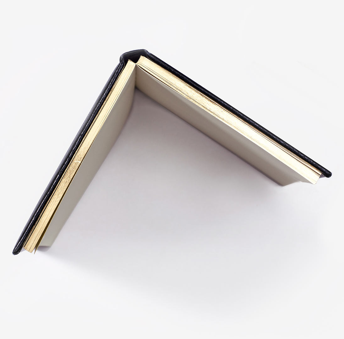 Open notebook with gold edging