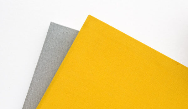 Grey and yellow clothbound notebook covers