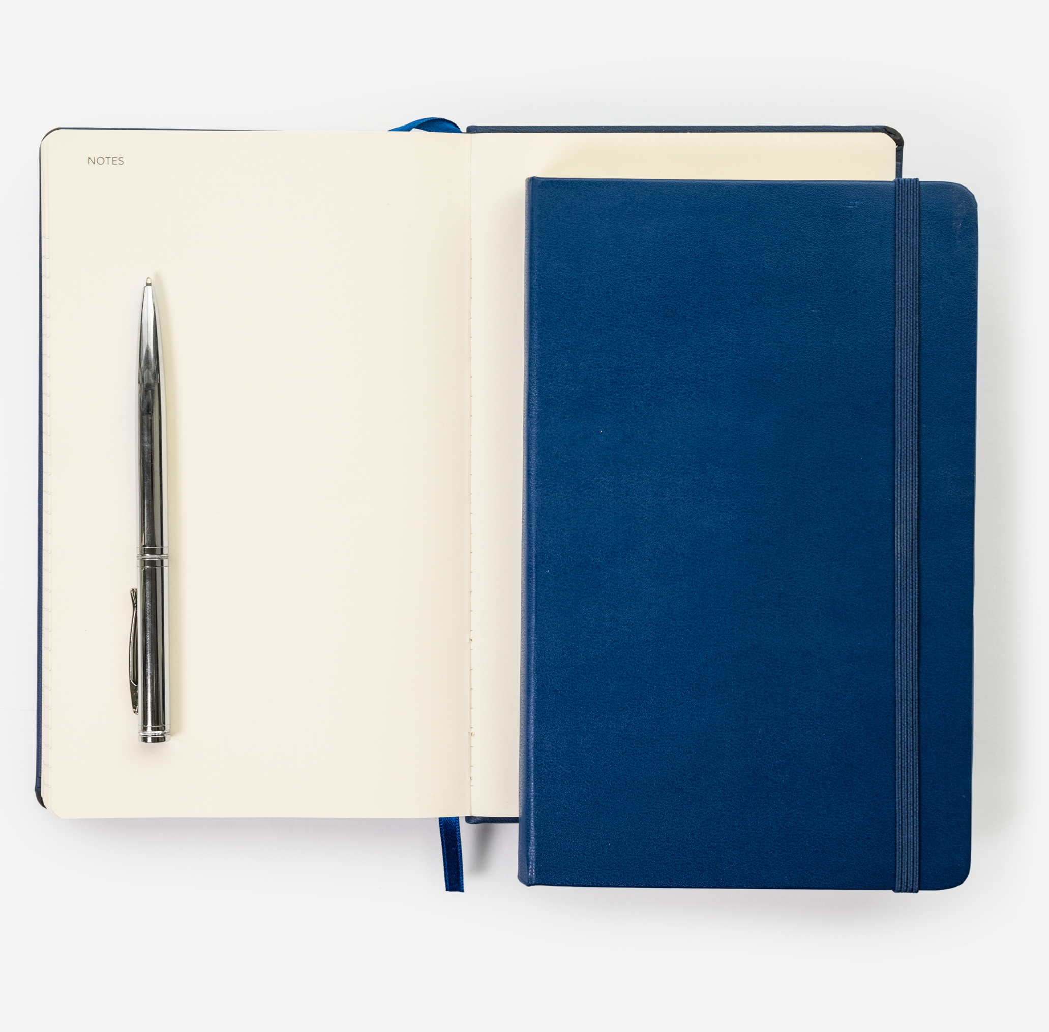 Stock-diary-inside-page Open diary with chrome metal pen and blue cover diary