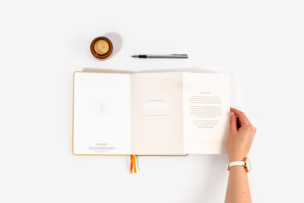 Open clothbound planner with printed pages