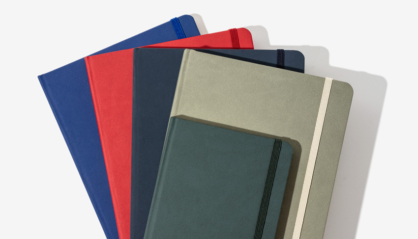 Set of various coloured silk touch notebooks covers by bookblock