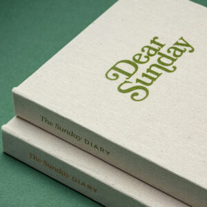 Dear sunday diary in cloth material with UV printed branding on cover and spine in green and red