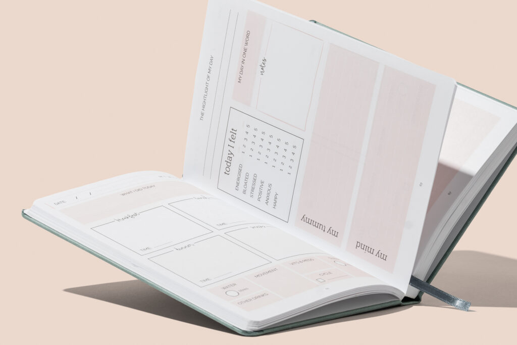Inside pages of my tummy diary bespoke gut health journal with custom printed pages
