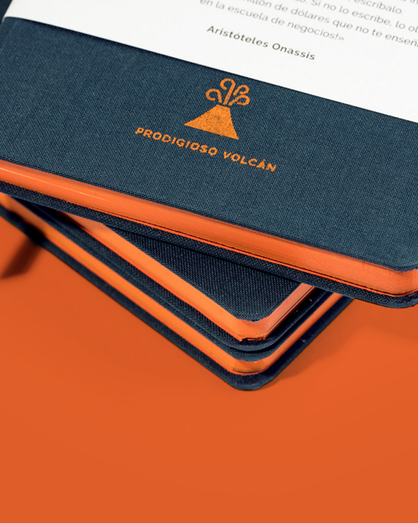 Prodigioso volcan screen printed logo on a cloth notebook with gilt edging and bespoke belly band